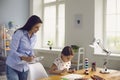 Child psychologist psychology. A woman psychologist with a clipboard works with a little girl patient in a children`s Royalty Free Stock Photo