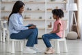Child psychotherapist having conversation with little girl Royalty Free Stock Photo