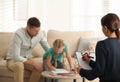 Child psychotherapist working with little girl and father in office Royalty Free Stock Photo