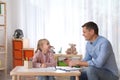 Child psychotherapist working with girl in office Royalty Free Stock Photo