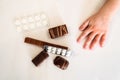 Child pulls a hand to candy and pills Royalty Free Stock Photo