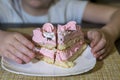 The child pulls his hands to pieces of cake. Royalty Free Stock Photo