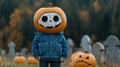 Child with pumpkin head in a spooky graveyard autumn ambiance Royalty Free Stock Photo