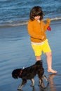 Child with his puppy dog on the beach Royalty Free Stock Photo