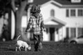 Child and puppy outside. Happy Kid boy and dog playing at backyard lawn. Pet walking. Royalty Free Stock Photo