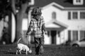 Child and puppy outside. Happy Kid boy and dog playing at backyard lawn. Pet walking. Royalty Free Stock Photo
