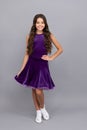 child in purple dance dress. dancing school. full length of kid with frizz hair. Royalty Free Stock Photo