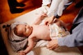 The child is put on clothes on a table in the Church. the ordinance of baptism.