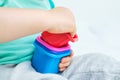 Child puts multi-colored toys in a stack