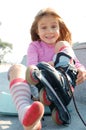 Child putting on her rollerblade skate Royalty Free Stock Photo