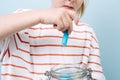 Child is putting used batteries in a jar for recycling. Royalty Free Stock Photo