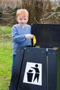 Child putting waste in bin Royalty Free Stock Photo