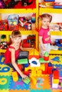 Child with puzzle, block in play room. Royalty Free Stock Photo