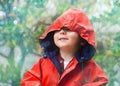 Child, rain and raincoat in style for fashion, jacket or cold weather in winter. Little boy, male toddler and kid in