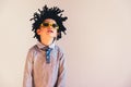 Child with rastafari wig dancing cheerful, isolated copy space white background