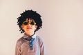 Child with rastafari wig dancing cheerful, isolated copy space white background