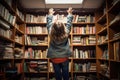 a child reaching for a book on the top shelf in a library