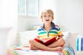 Child reading book in bed. Kids read in bedroom Royalty Free Stock Photo