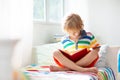 Child reading book in bed. Kids read in bedroom Royalty Free Stock Photo