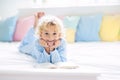 Child reading book in bed. Kids read in bedroom Royalty Free Stock Photo