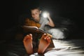 Child reading book in bed. Kids read at night. Little boy with fairy tale books in bedroom . Education for young