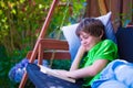 Child reading a book in the garden Royalty Free Stock Photo