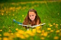 Child reading a book while lying