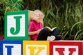 Child reading book. Kid learning letters Royalty Free Stock Photo
