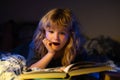 Child reading a books. Kids bedtime, boy reading a book in bed. Bedtime stories fairy story before bed.