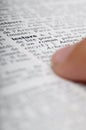 Child reading with his finger on dictionary