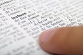 Child reading with his finger on dictionary