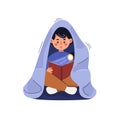 Child reads book under blanket with flashlight.