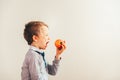 Child ready to eat an apple at a bite, isolated on white background with copy space Royalty Free Stock Photo