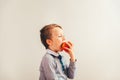 Child ready to eat an apple at a bite, isolated on white background with copy space Royalty Free Stock Photo