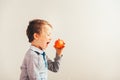 Child ready to eat an apple at a bite,  on white background with copy space Royalty Free Stock Photo