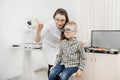 Child reception doctor ophthalmologist selects glasses of lens, check eye sight.