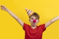 Child with red clown nose on yellow background. Cheerful clown boy. 1 April Fools day concept Royalty Free Stock Photo