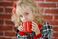 Child with red cup of hot cocoa or chocolate with marshmallow Royalty Free Stock Photo