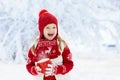 Child drinking chocolate on Christmas in snow