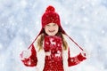 Child playing in snow on Christmas. Kids in winter Royalty Free Stock Photo