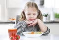 Child refuses to eat,not hungry kid.No appetite.Unhappy expression. Little girl does not want to eat