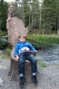 Child relaxing on stump chair Royalty Free Stock Photo