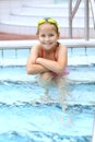 Child relaxing by swimming pool Royalty Free Stock Photo