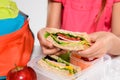 Child removing wholemeal sandwich out of lunchbox Royalty Free Stock Photo