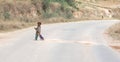 Child repairing the road. Instead of going to school children often work to make money