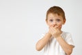 Child holds back the emotion of fear by covering his mouth with his hands Royalty Free Stock Photo