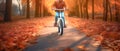 Child rides a bike in city park. Small child is learning to ride a bike on an asphalt road in the autumn forest. Generative AI