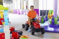 A child rides a toy pedal car at a children's play center Royalty Free Stock Photo