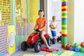 A child rides a toy pedal car at a children& x27;s play center Royalty Free Stock Photo