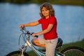 Child riding bicycle. Little kid boy on bicycle along bikeway. Happy cute little boy riding bicycle in summer park